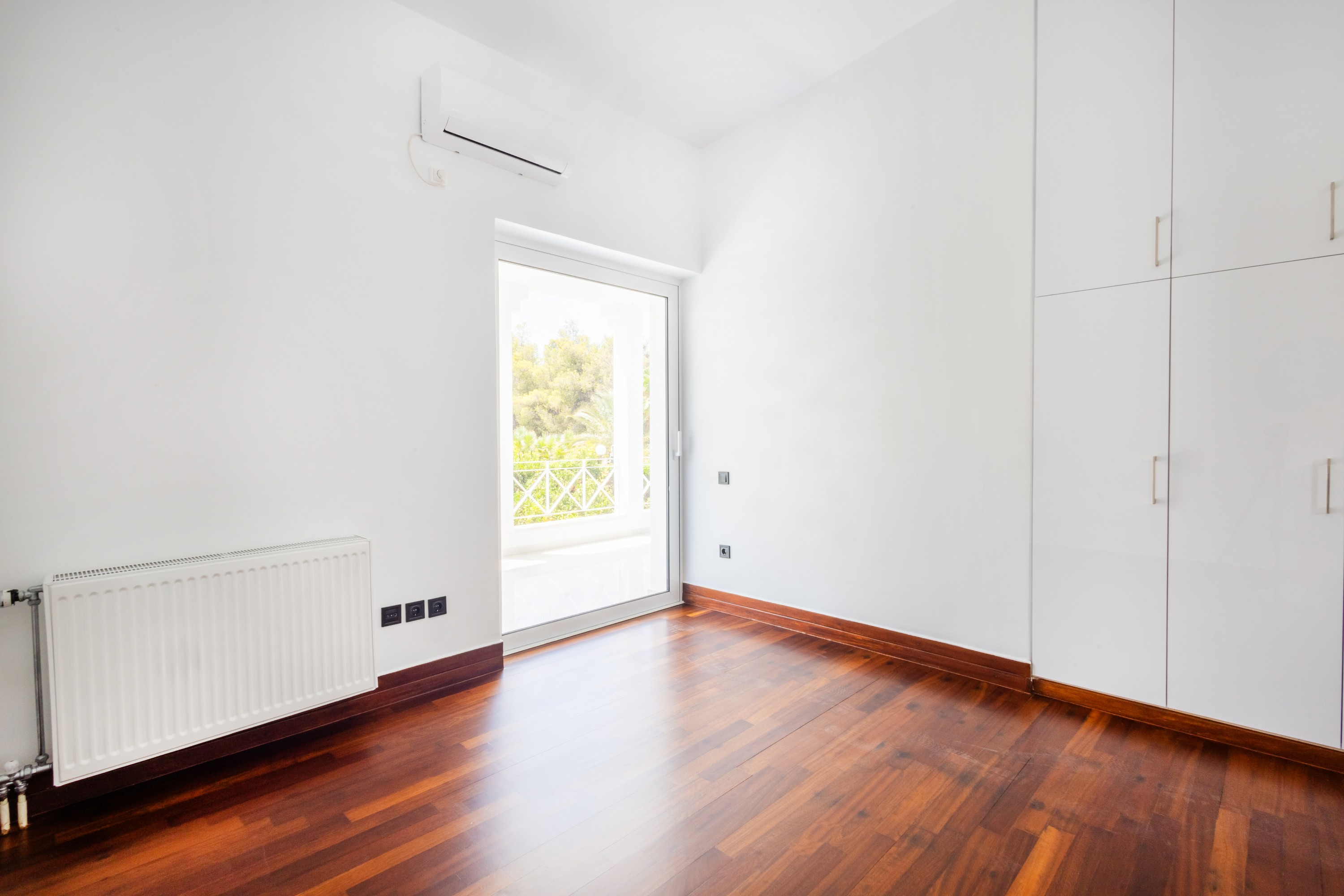 Bedroom with fitted wardrobes and direct covered-balcony access