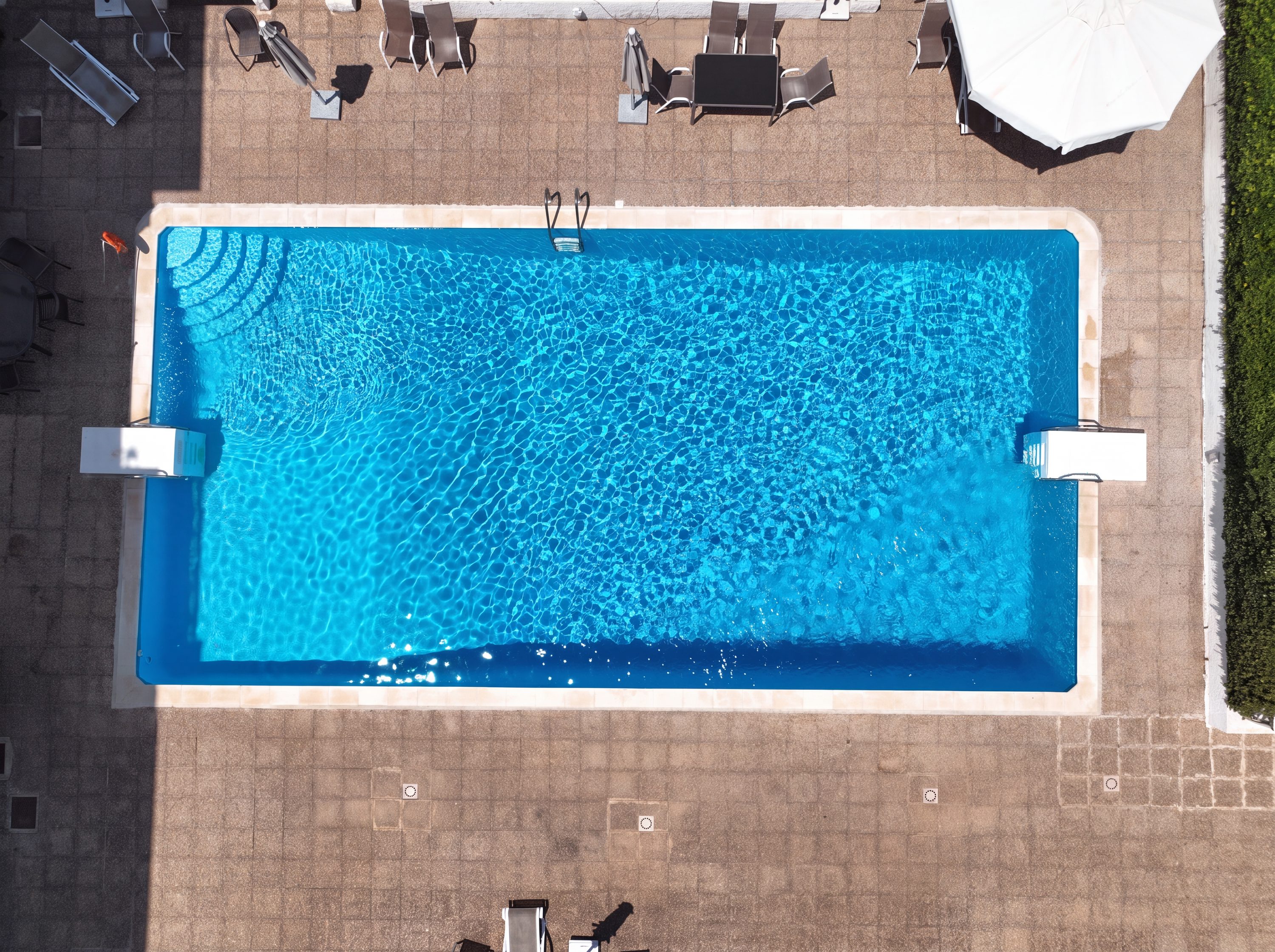 Aerial view of the shared residents' swimming pool and surrounding sun terrace